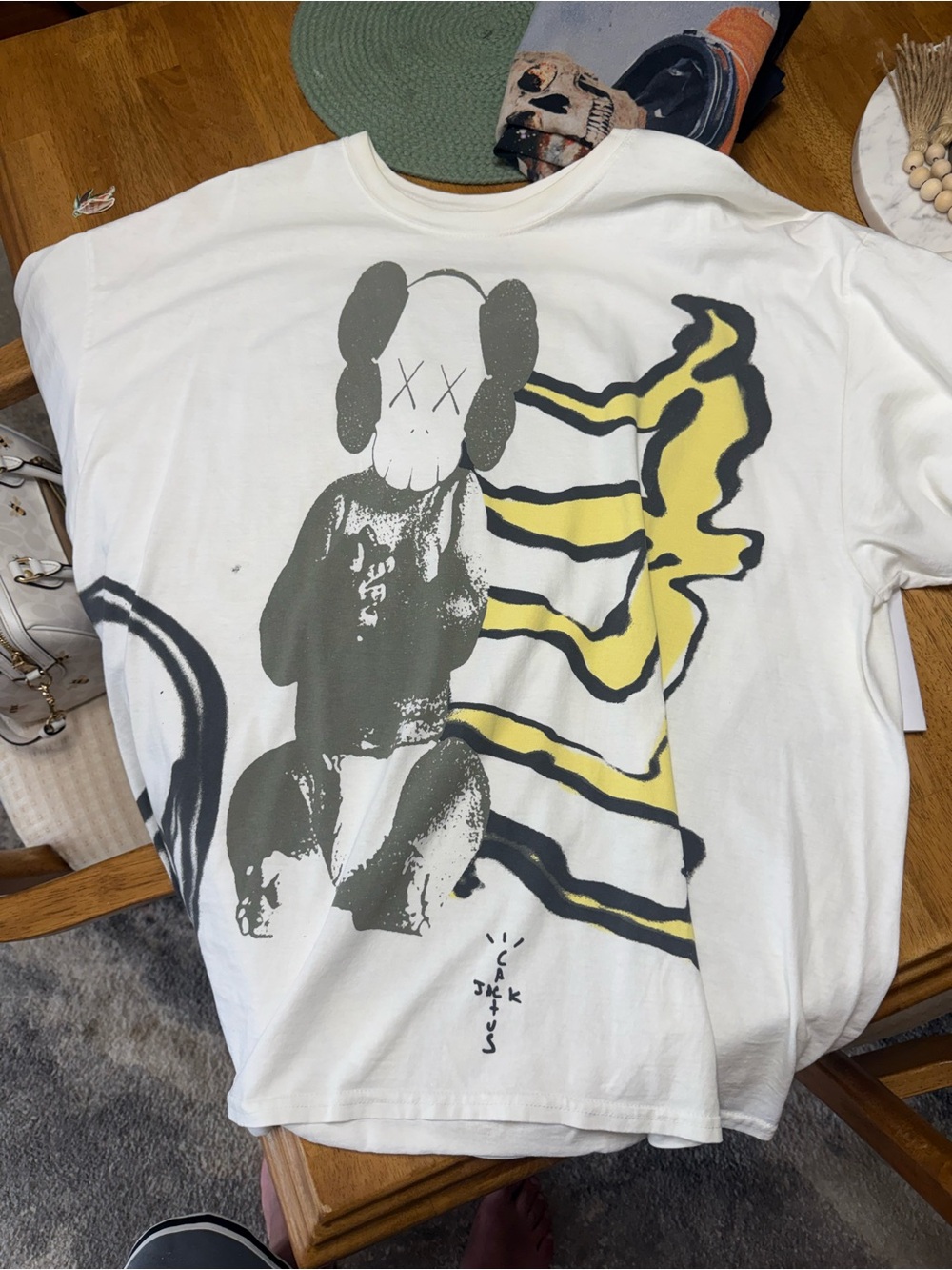 Travis Scott / kaws White Tee with Gray Character & Yellow Accent Graphic